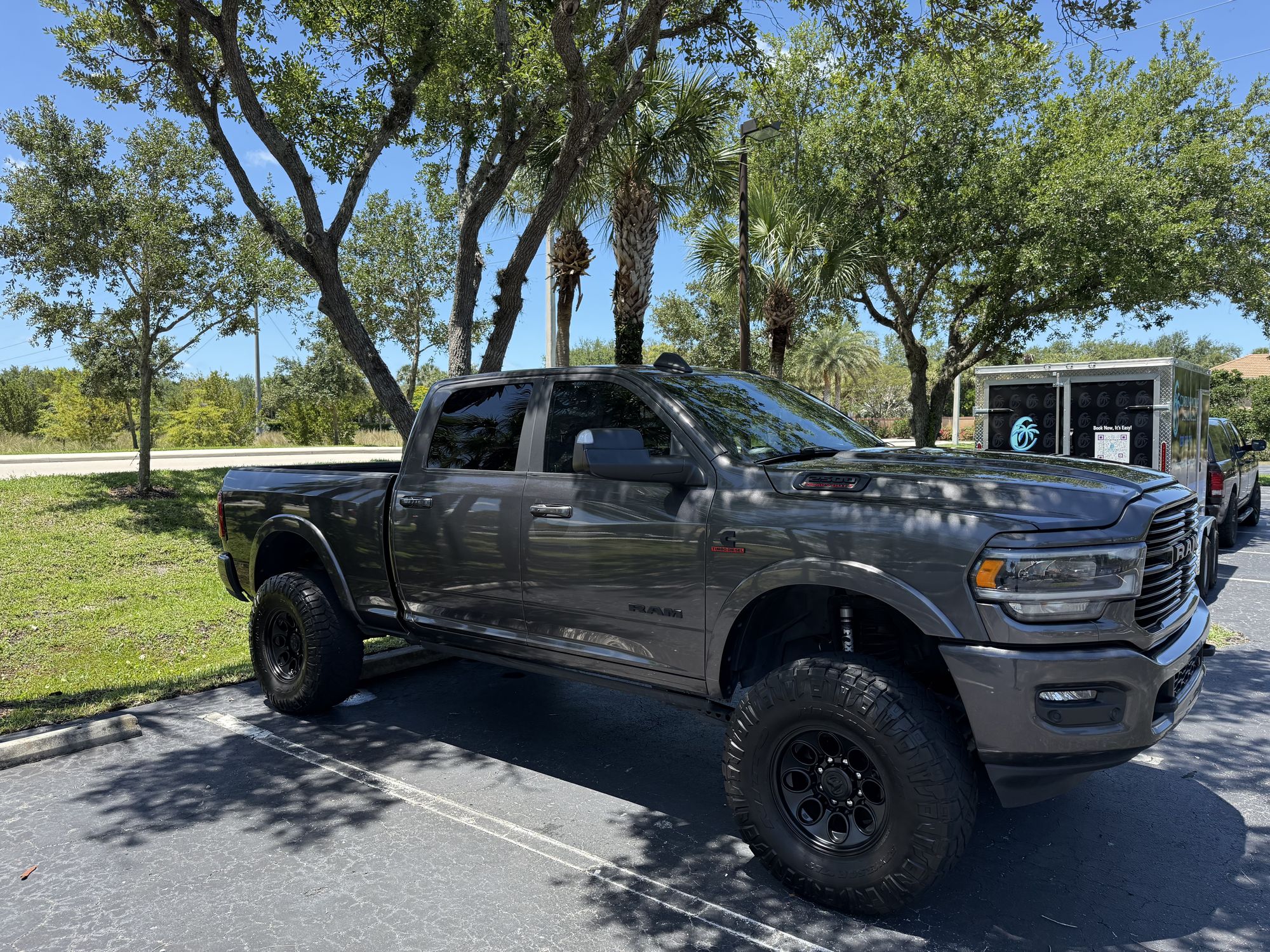 Lifted RAM 2500 pickup next to the Coastline trailer